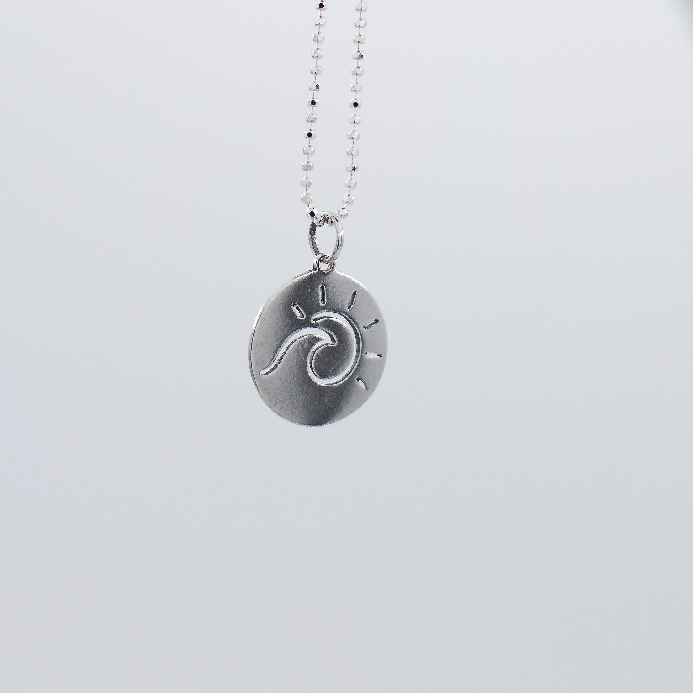 Sun and wave pendant