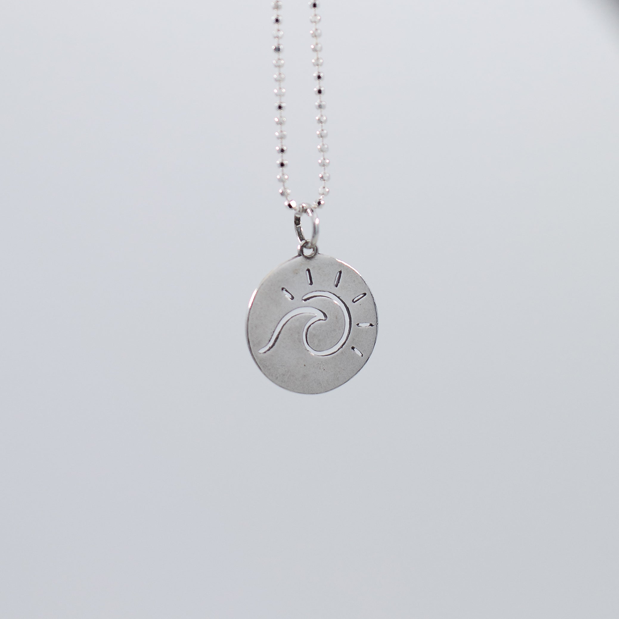 Sun and wave pendant